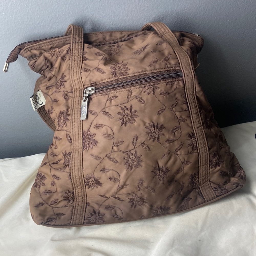 It’s brown and it has flower designs on it with a zipper in the front,
